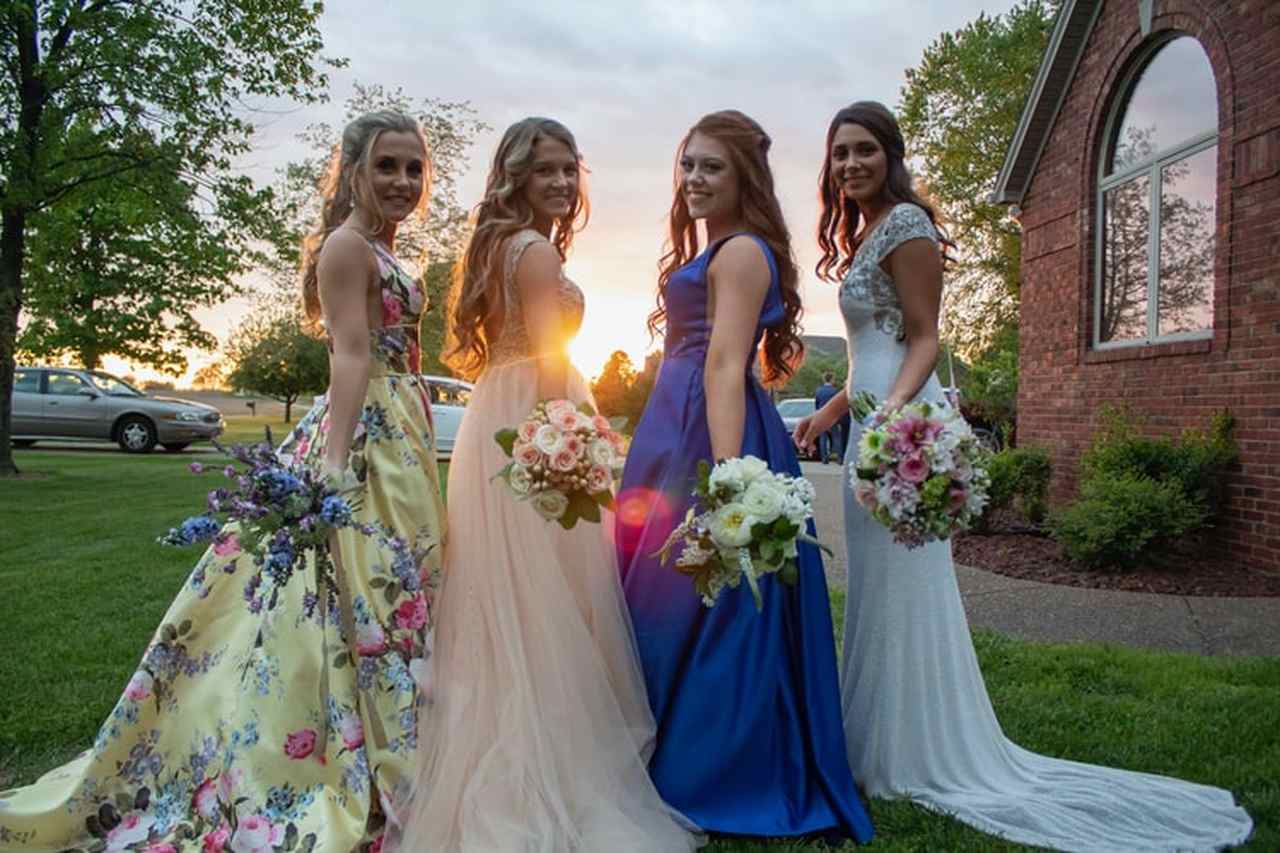 4 fancy bridesmaids holding flower bouqets