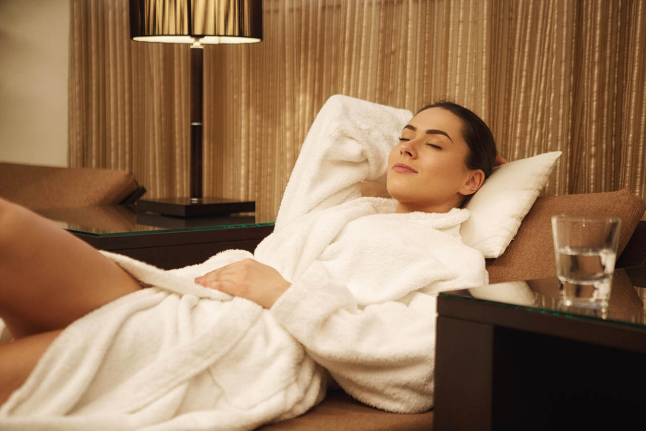 woman laying down with white robe