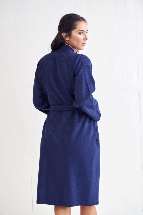 a woman who wears a blue bathrobe